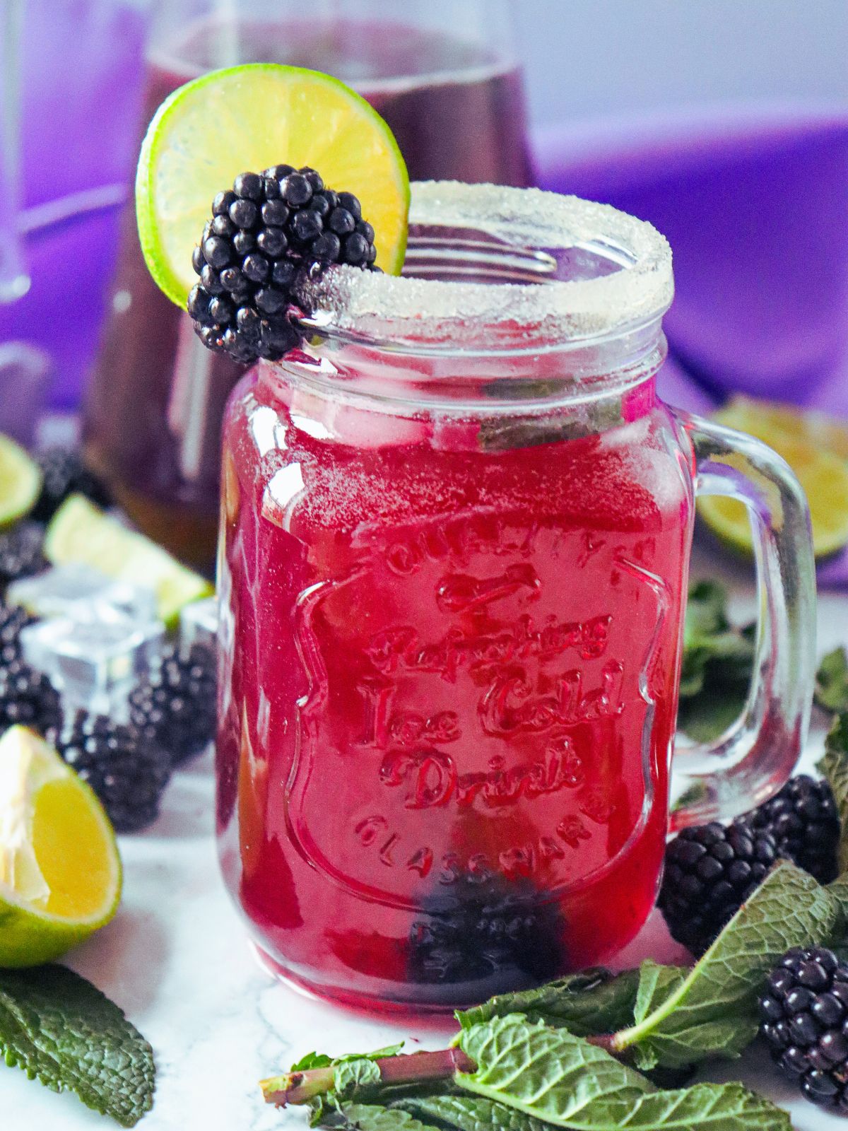 infused mocktail with fruit, limes and mint in mason jar glass.