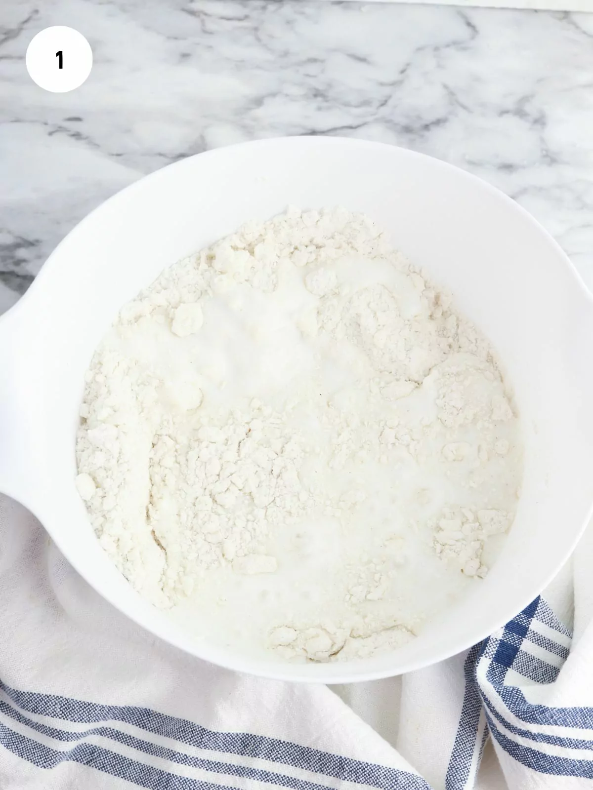 Mixing bowl with flour, baking powder, baking soda, salt, and sugar