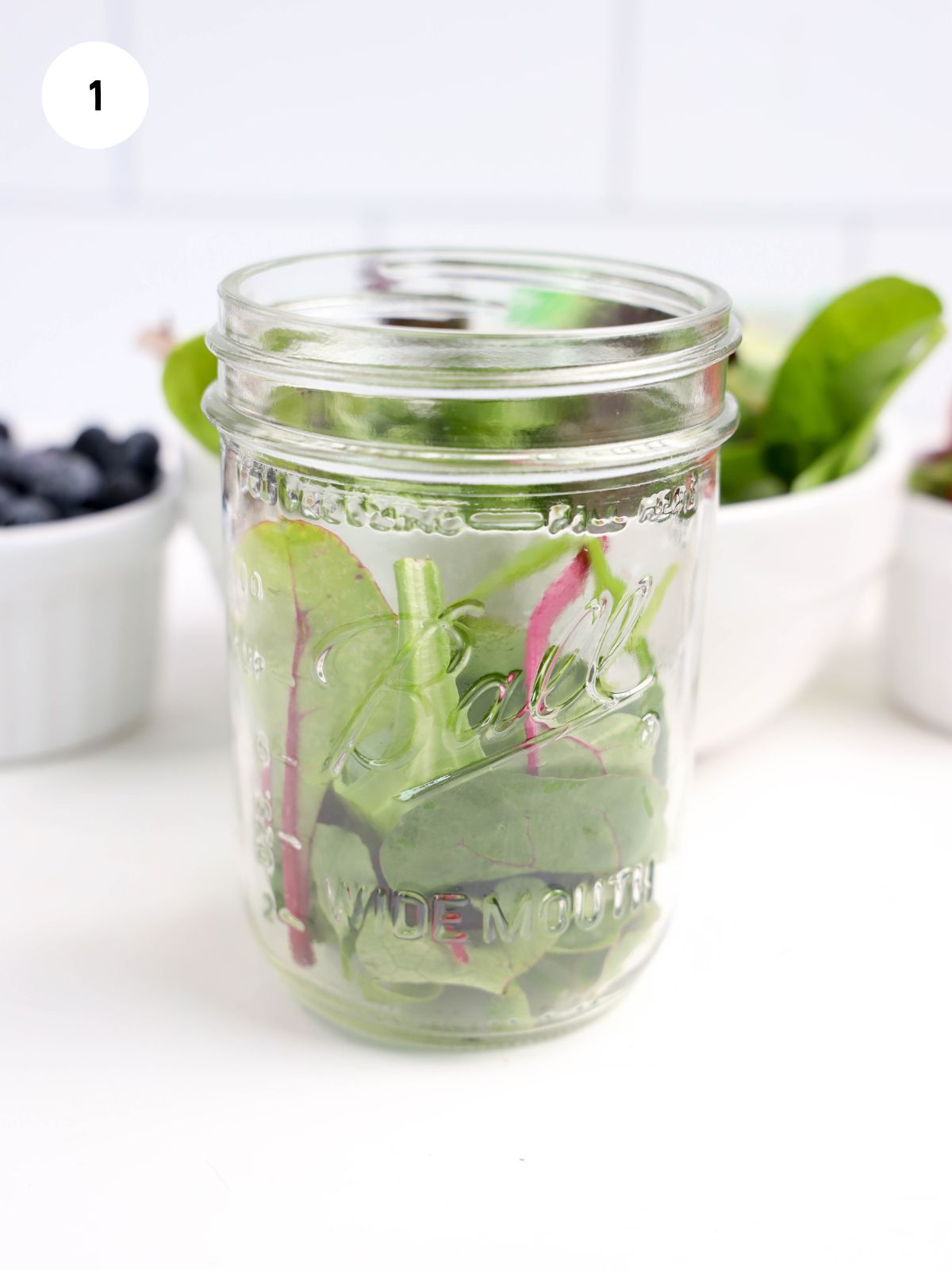 salad mix added to the bottom of a mason jar
