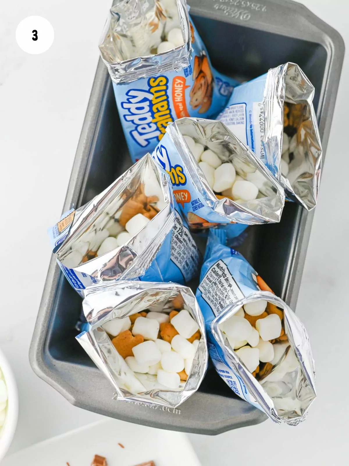 Add mini marshmallows to the bags
