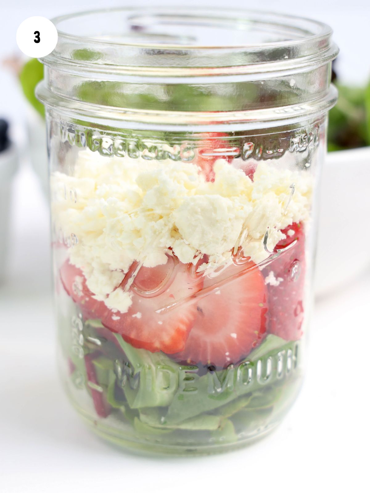 Feta cheese added on top of the strawberries