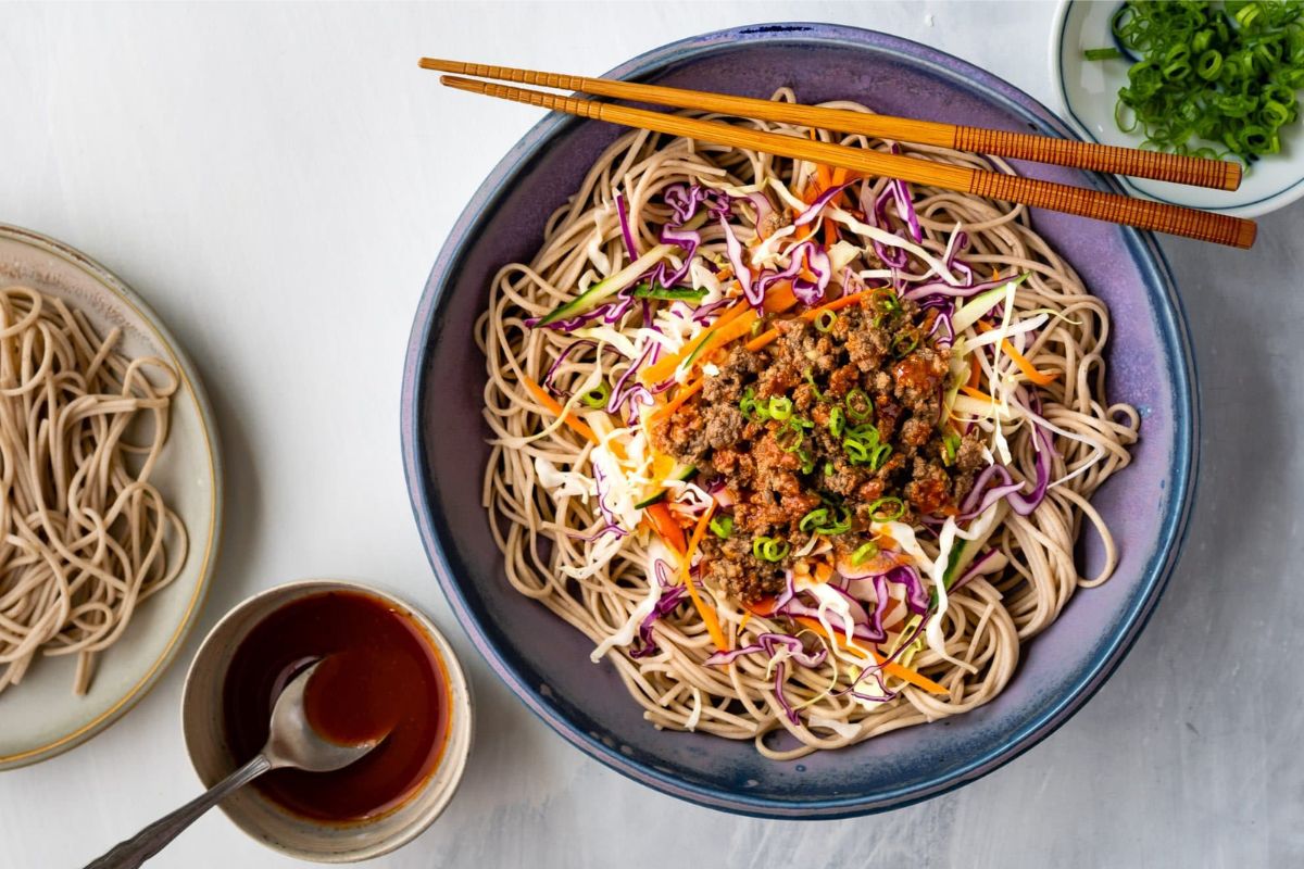 Beef Soba Noodles served in bowl with chopsticks.