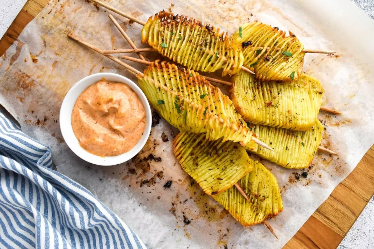 Accordion cut potatoes served on sticks.