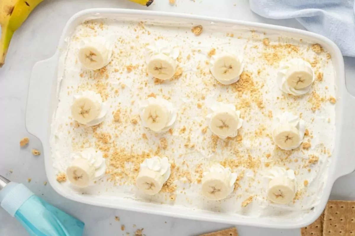 banana layer cake in casserole dish made with pudding and graham crackers.