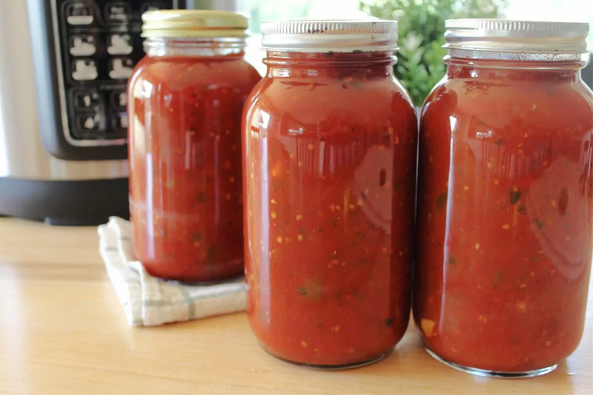 3 mason jars of canned tomatoes using the water bath method.