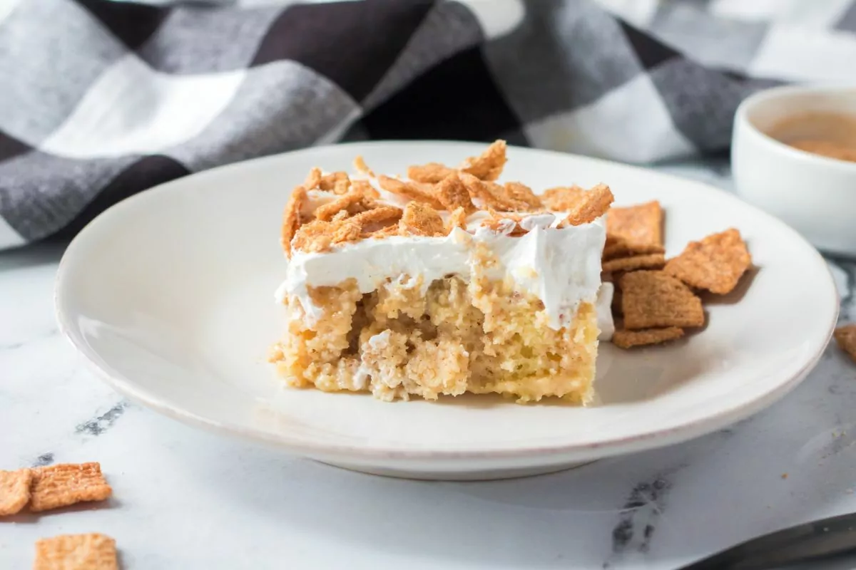 dump cake with cereal squares as garnish on white plate.