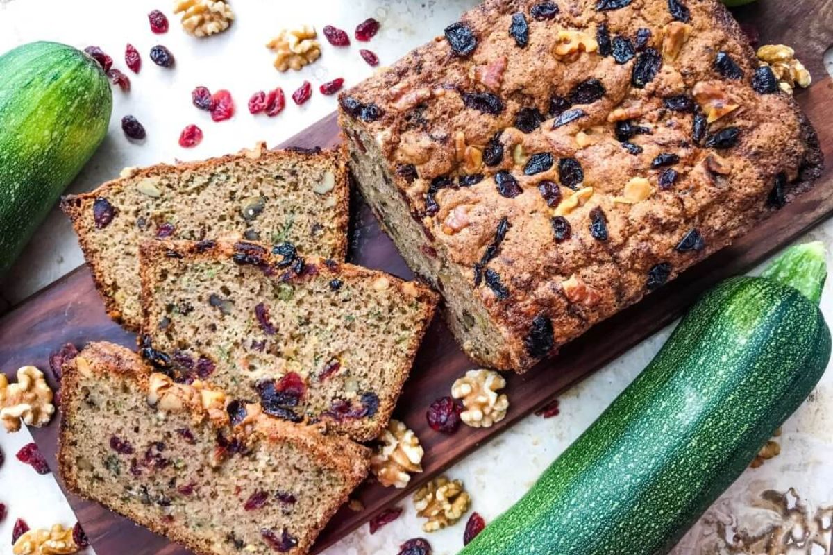 Cranberry Walnut Zucchini Bread sliced on cutting board.