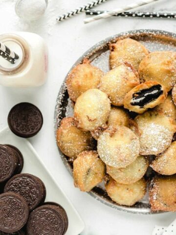 a pan of deep fried, battered oreo cookies.