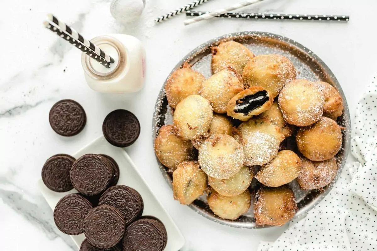 a pan of deep fried, battered oreo cookies.