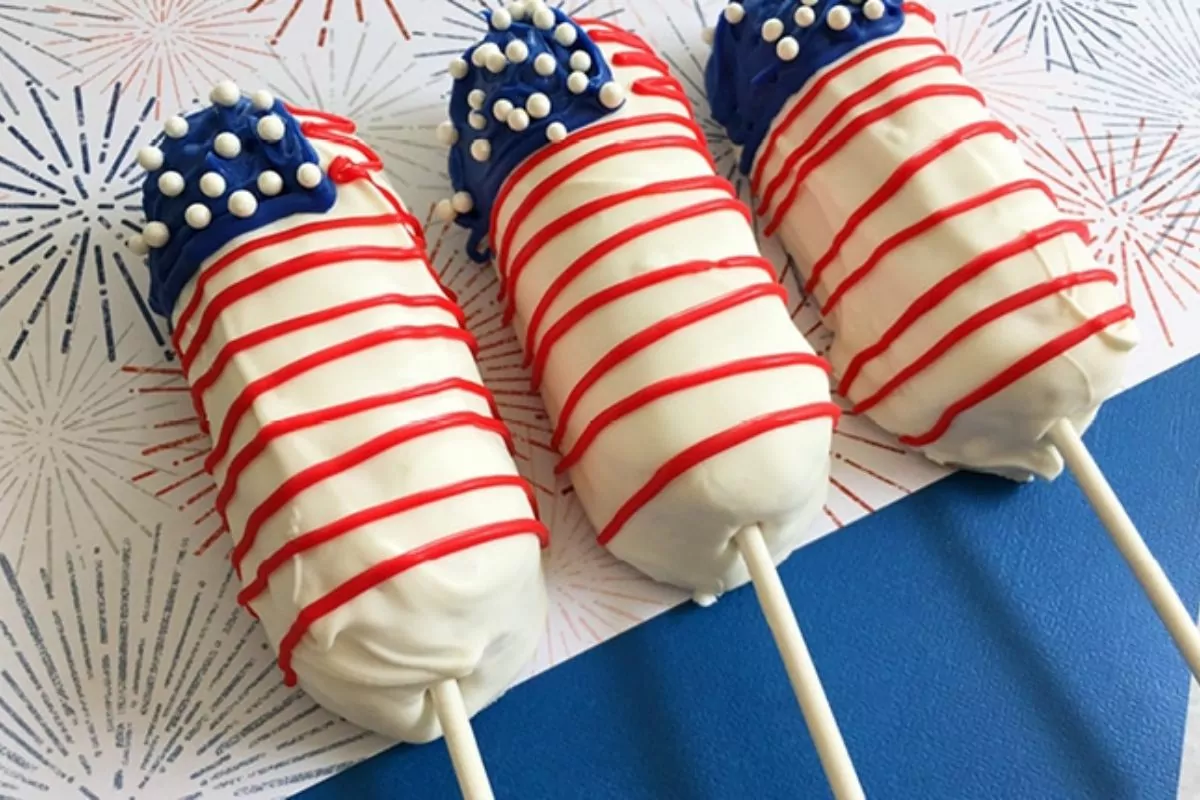 twinkies dipped in white chocolate and decorated to look like a flag on a stick.
