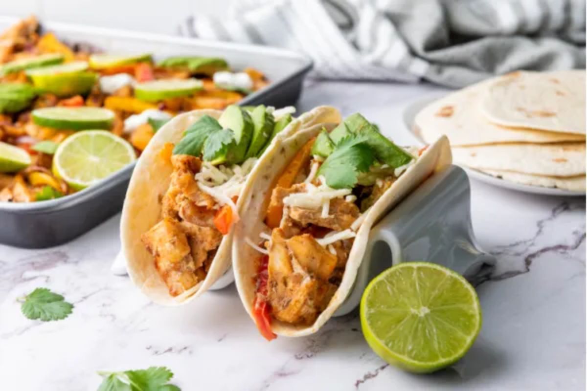 Sheet Pan Chicken Fajitas with lime cut in half.