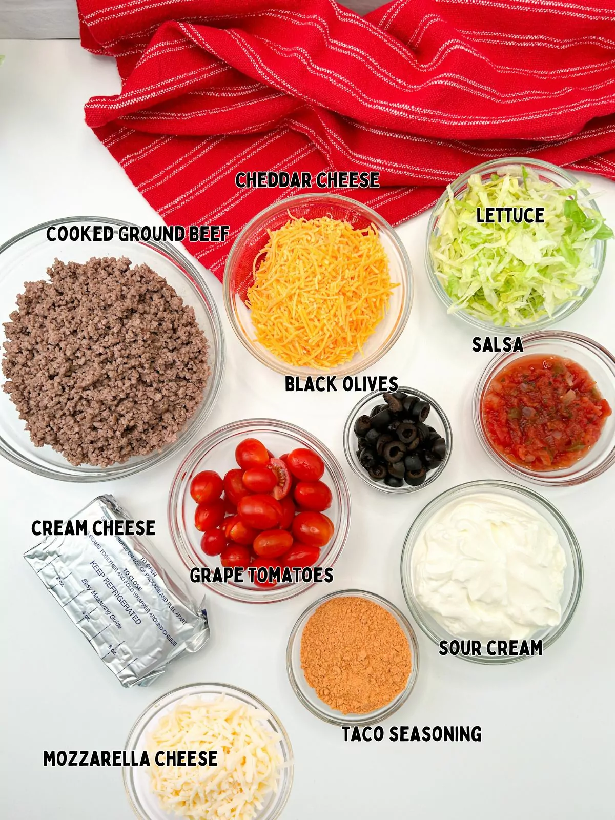 Ingredients for taco salad in small bowls.