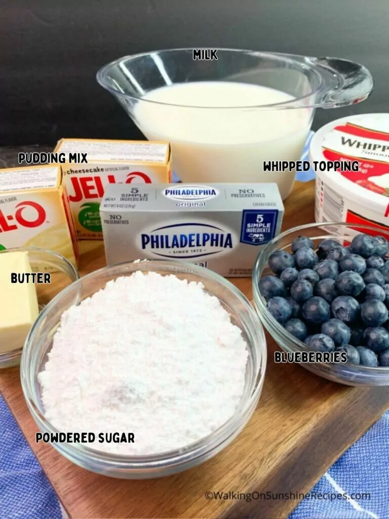 ingredients in bowls and on cutting board for cheesecake pudding.