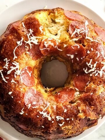 Overhead view of bread baked in bundt pan with pepperoni and cheese.