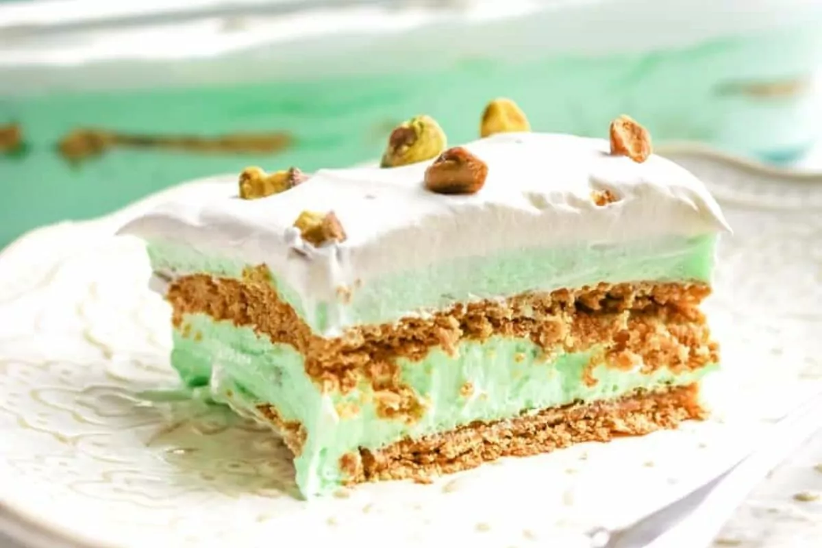 A slice of pistachio pudding icebox cake on a plate.