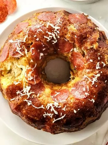 full overhead photo of monkey bread with pepperoni, cheese and spices.