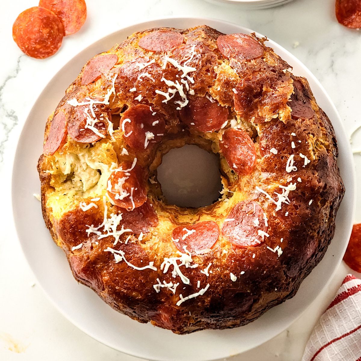 full overhead photo of monkey bread with pepperoni, cheese and spices.