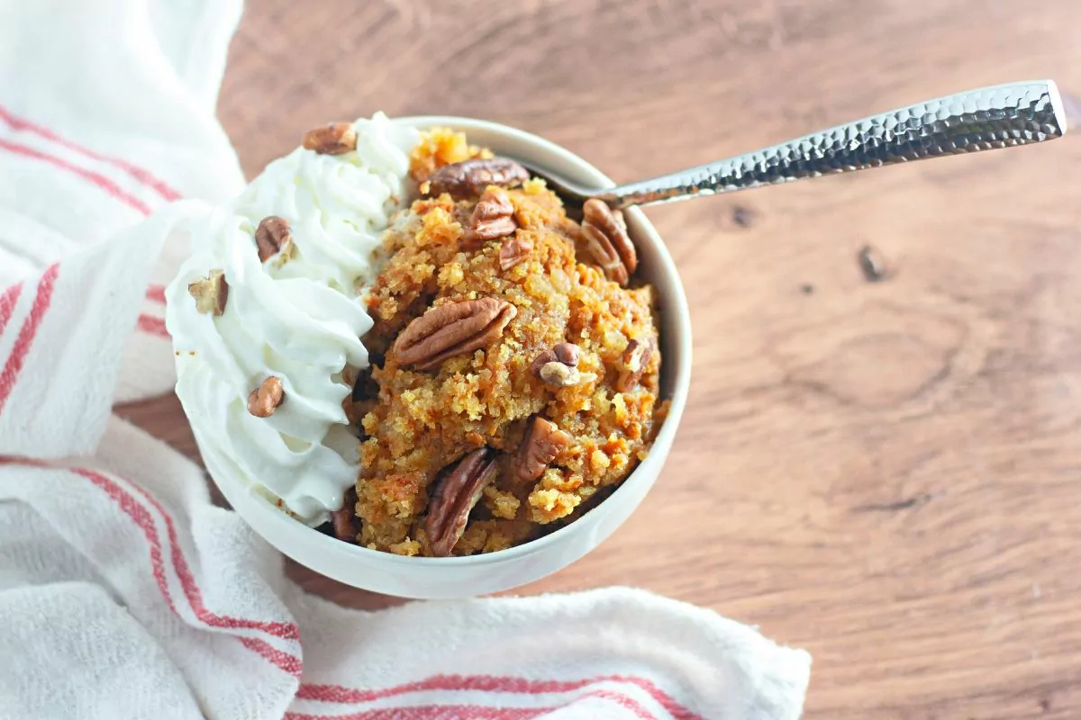 pumpkin cobbler with walnuts and whipped cream.