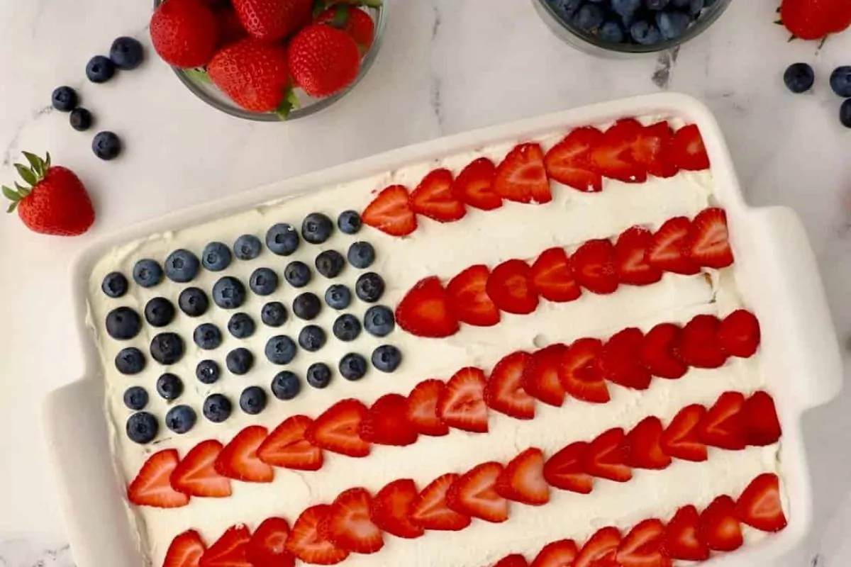 vanilla frosted cake with blueberries and strawberries to look like a flag.