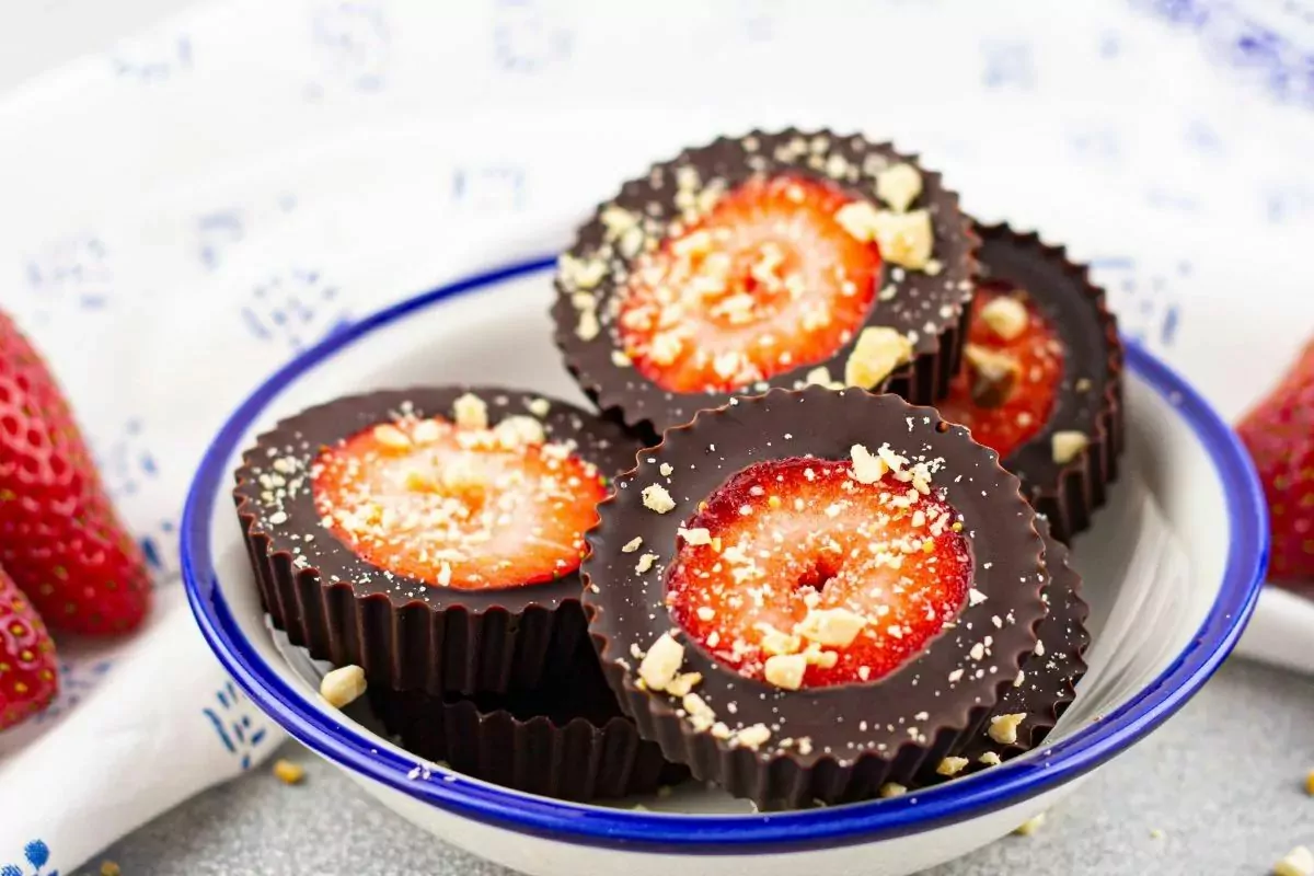 strawberry slices surrounded by chocolate in bowl.