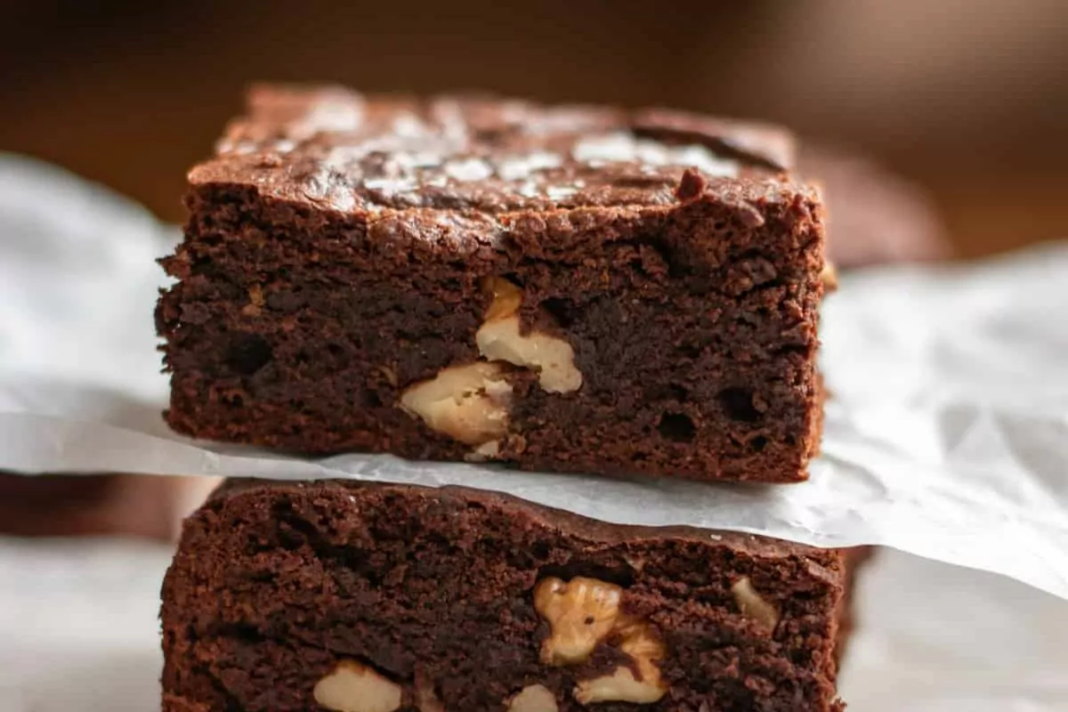 A stack of brownies with walnuts.