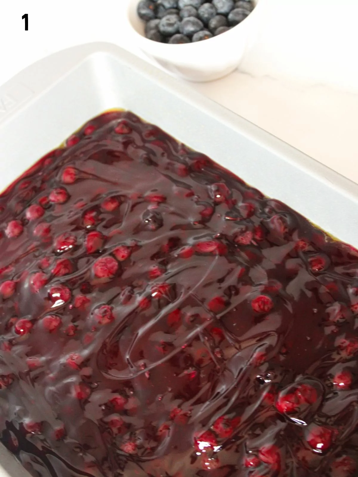 blueberry pie filling in casserole dish.