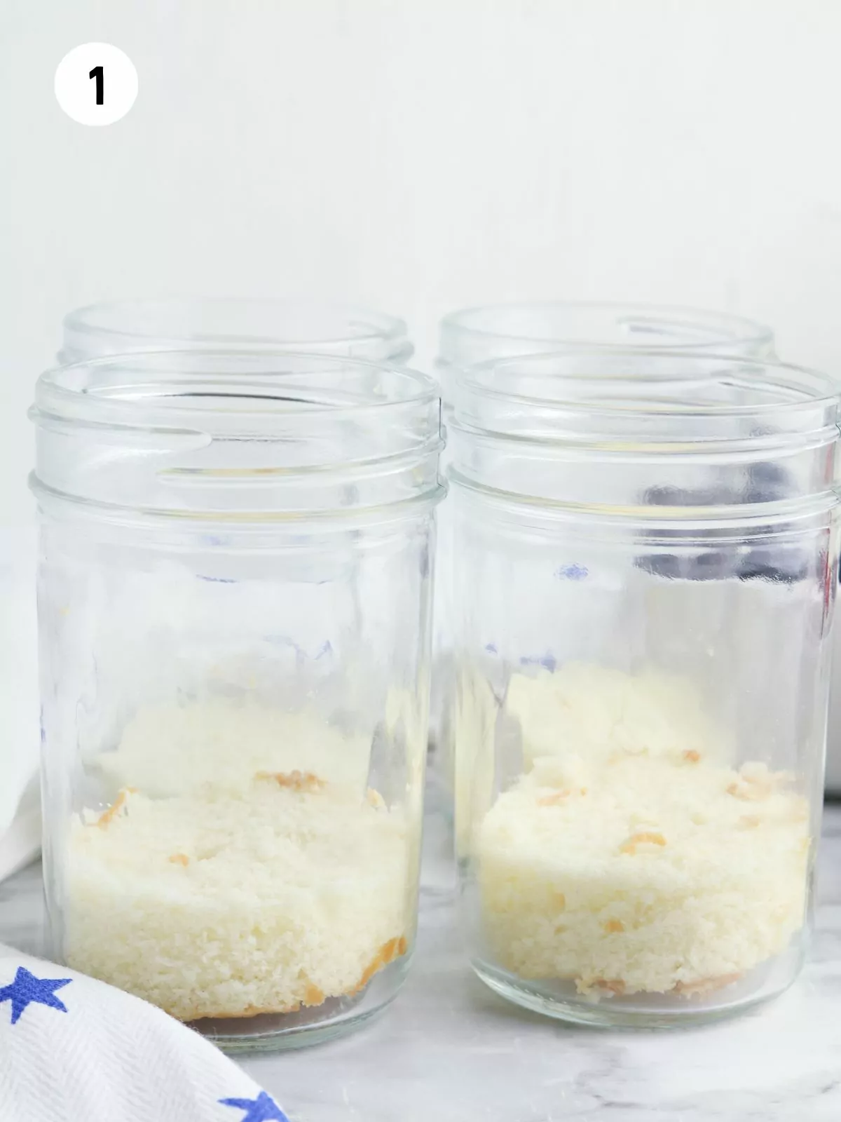 cubed pound cake in the bottom of jars.