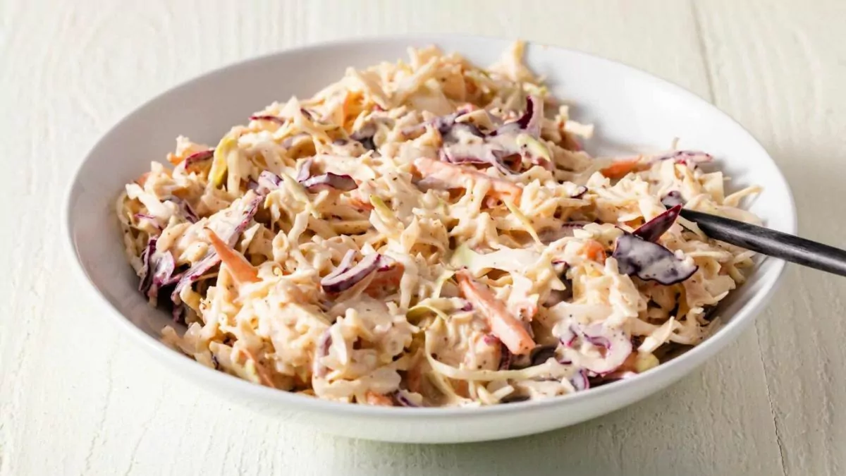 a bowl of coleslaw with homemade bbq mayo dressing