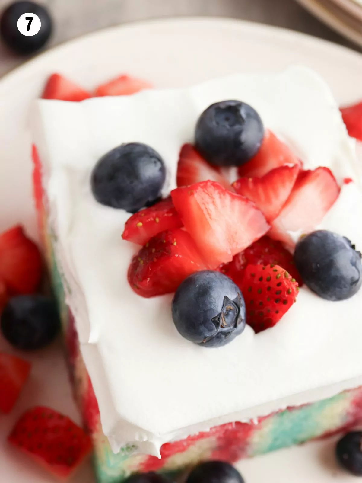 close up of decorated cake with blueberries and strawberries.