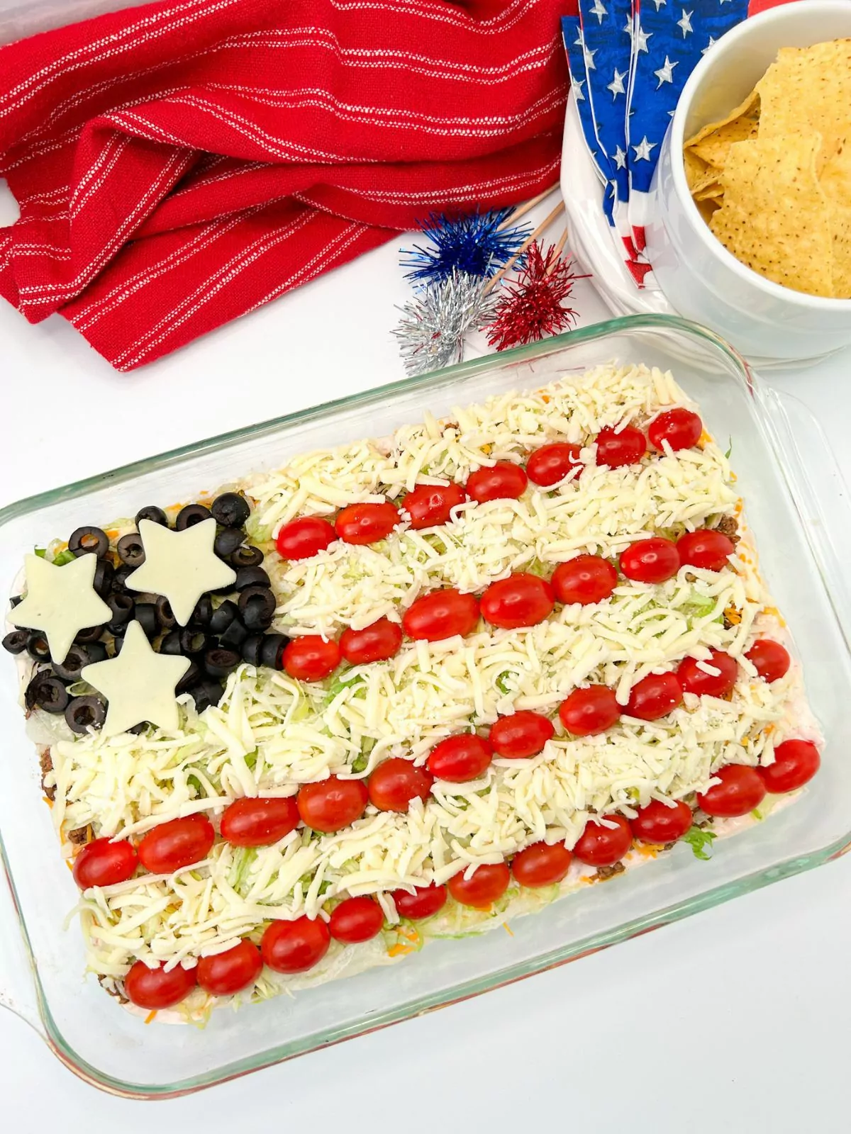 completed taco salad dip in casserole dish decorated like the American flag.
