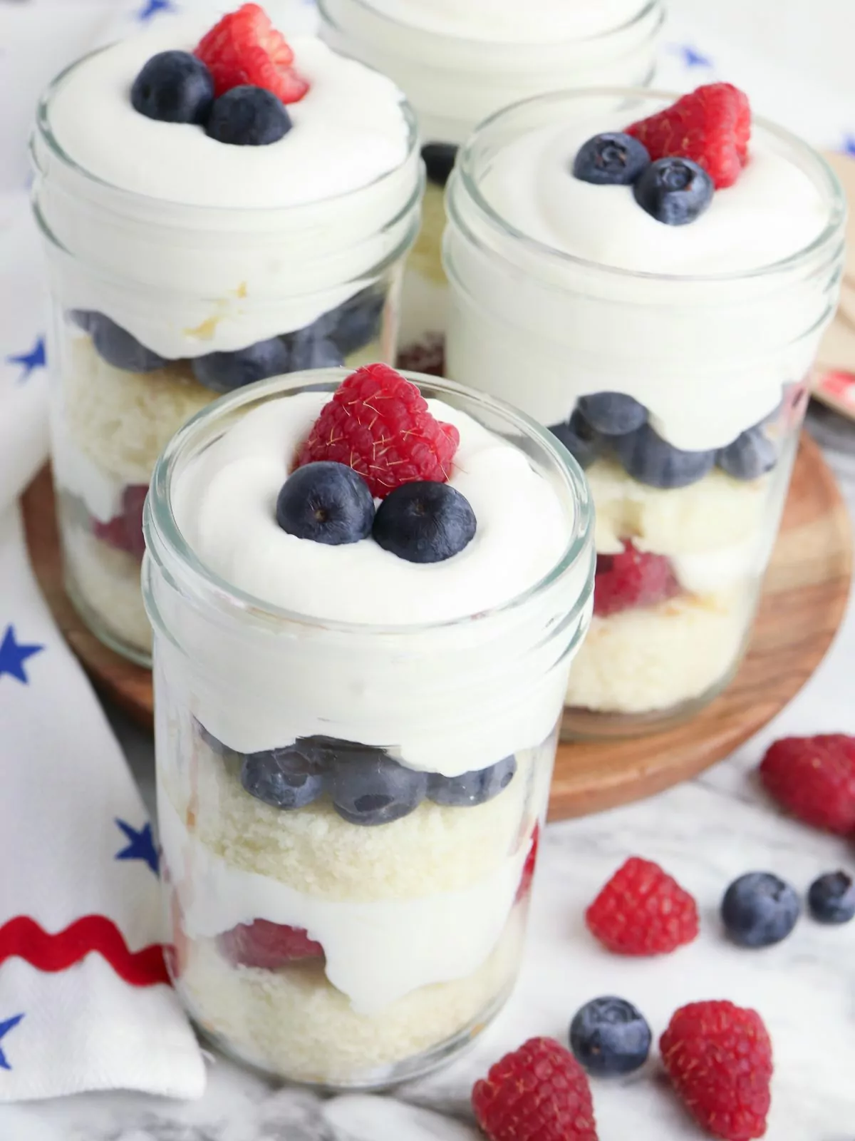 3 jelly canning jars filled with a fun red, white and blue dessert.