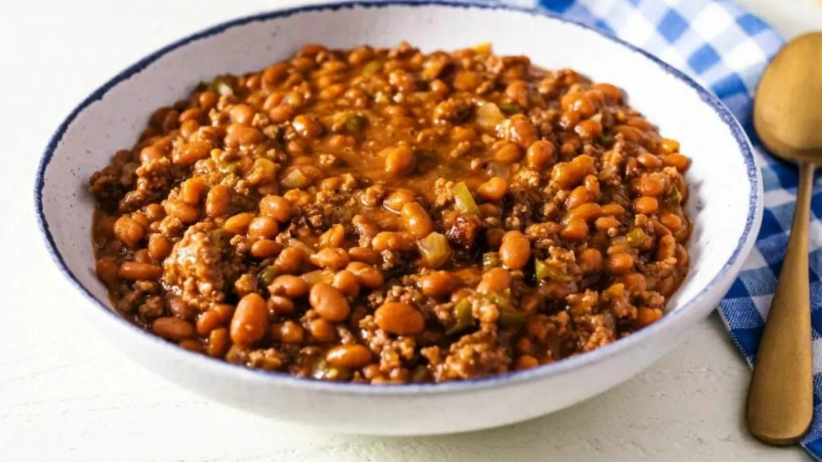 a bowl of baked beans with ground beef mixed in.