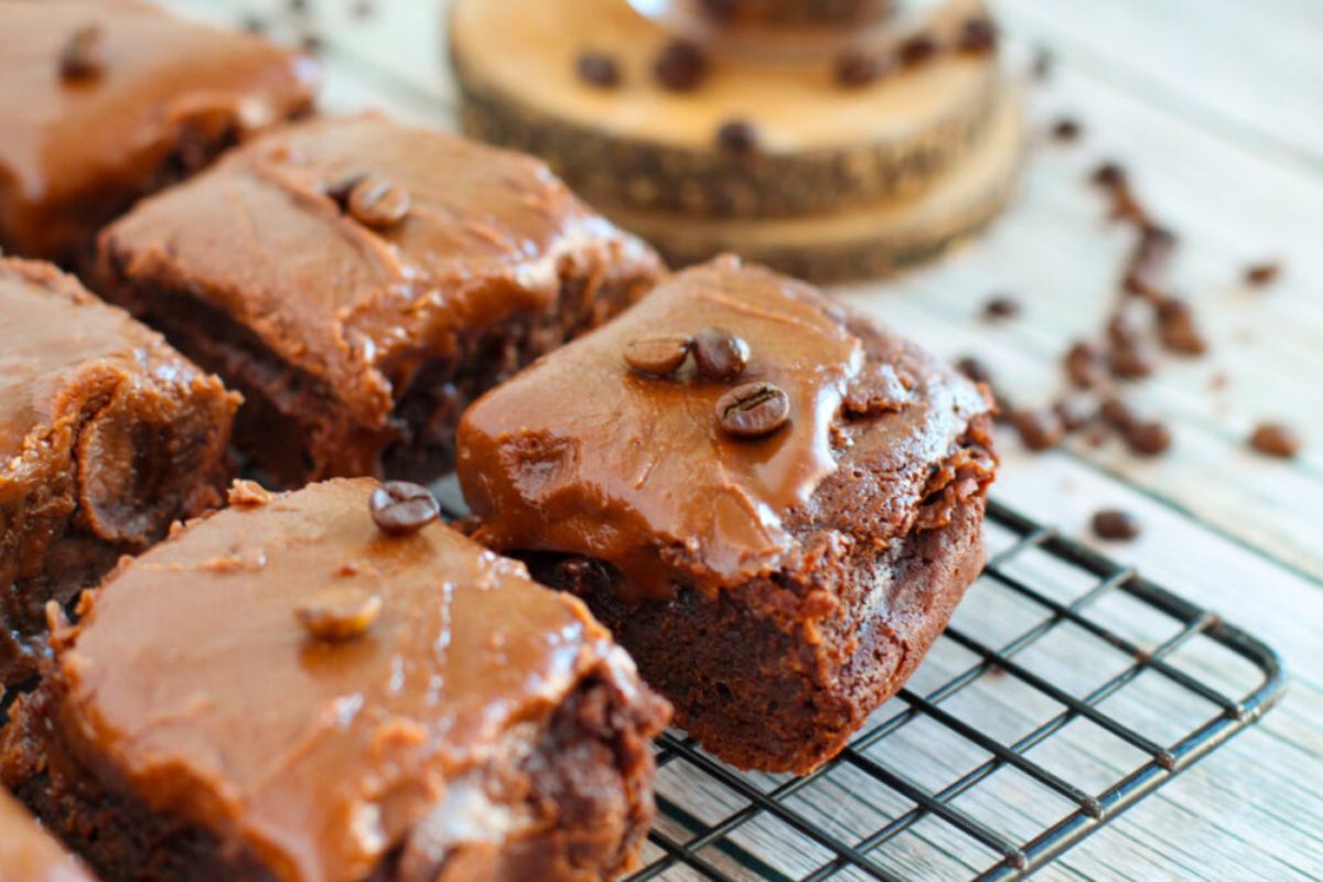 brownies topped with frosting and coffee beans.