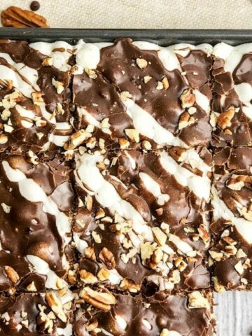 brownies topped with marshmallows, chocolate sauce and walnuts made in a sheet pan.