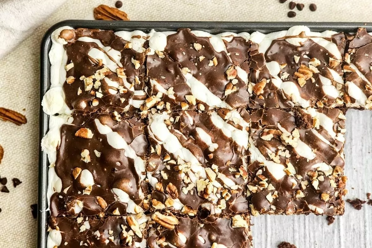 brownies topped with marshmallows, chocolate sauce and walnuts made in a sheet pan.