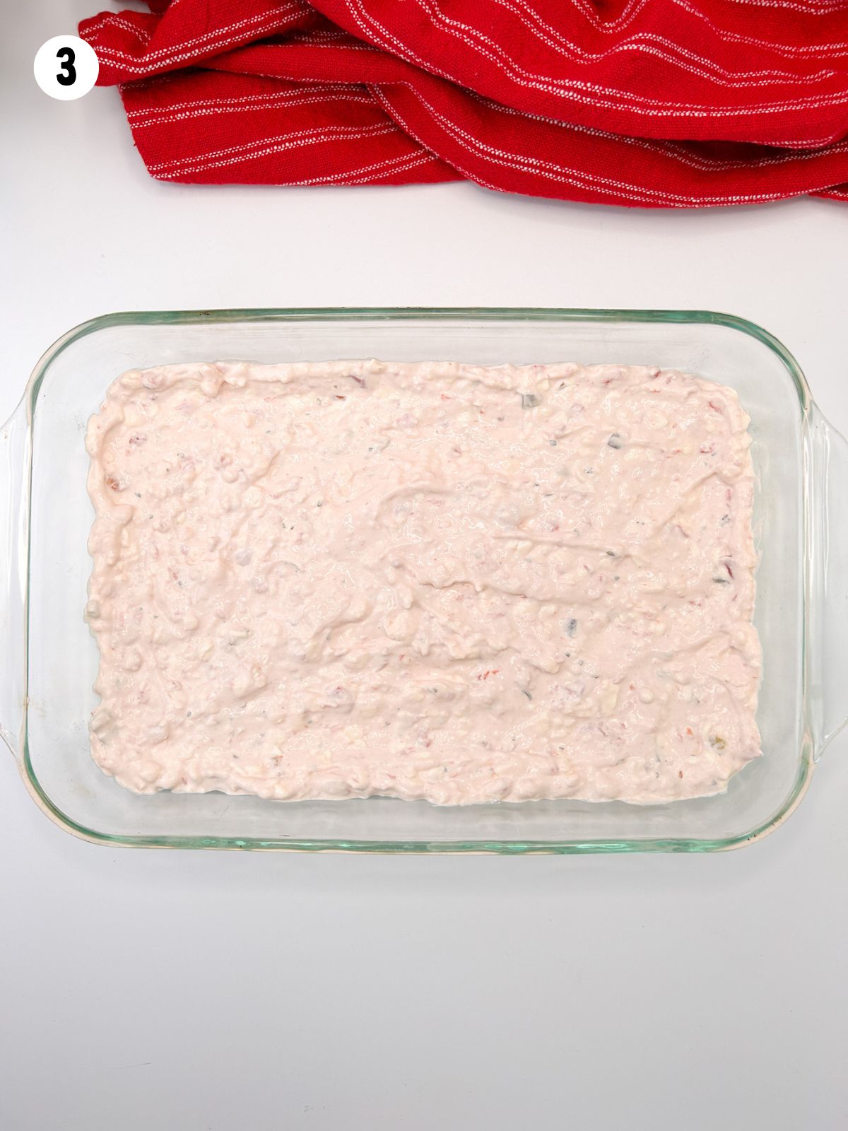 salsa, cream cheese, sour cream base dip in casserole dish.