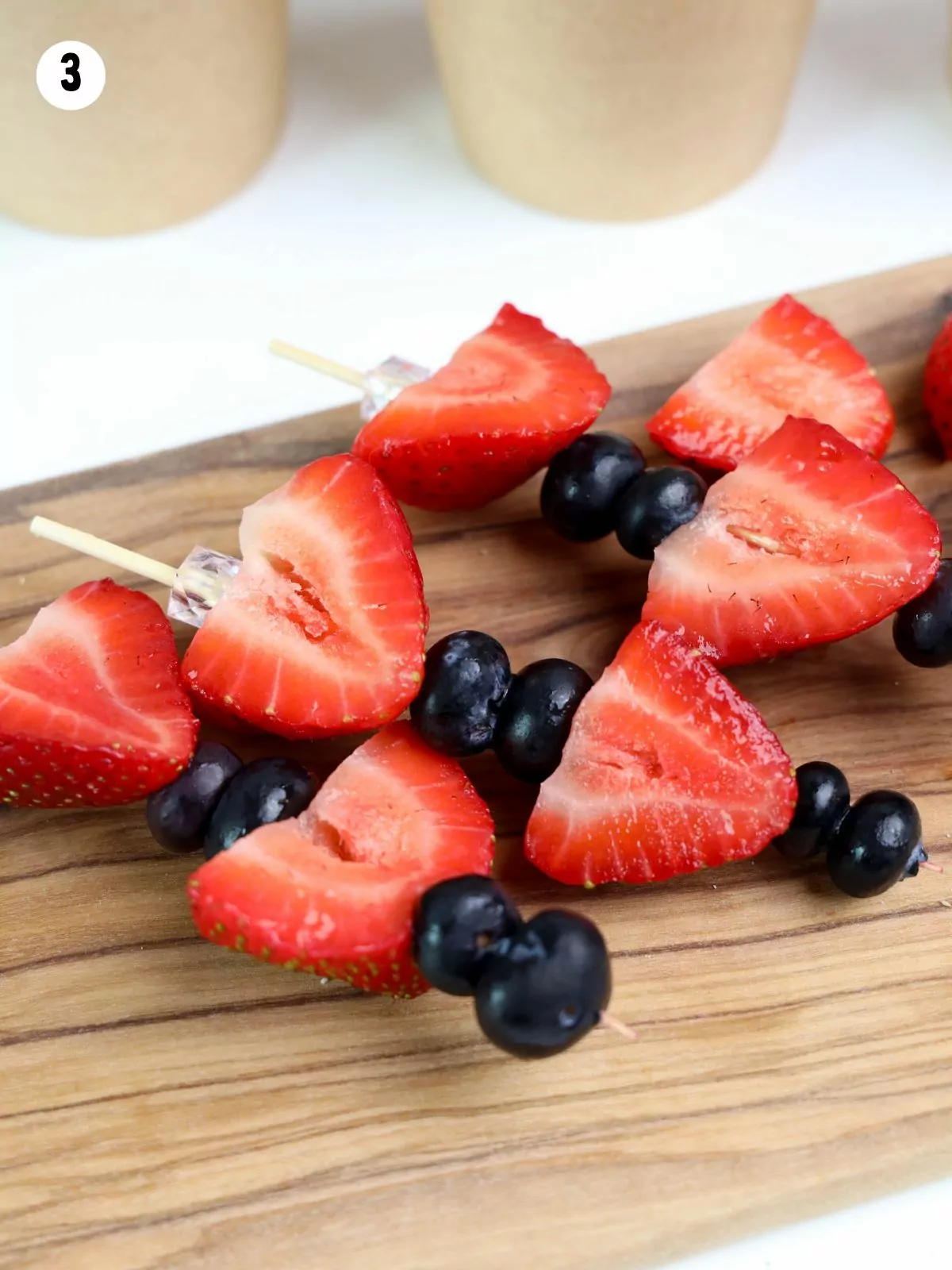 blueberries and strawberries on a toothpick.