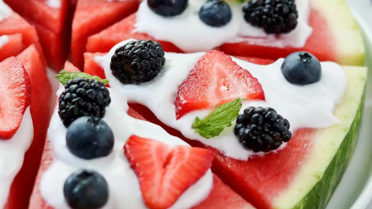 a watermelon pizza with homemade coconut cream and fresh berry toppings.