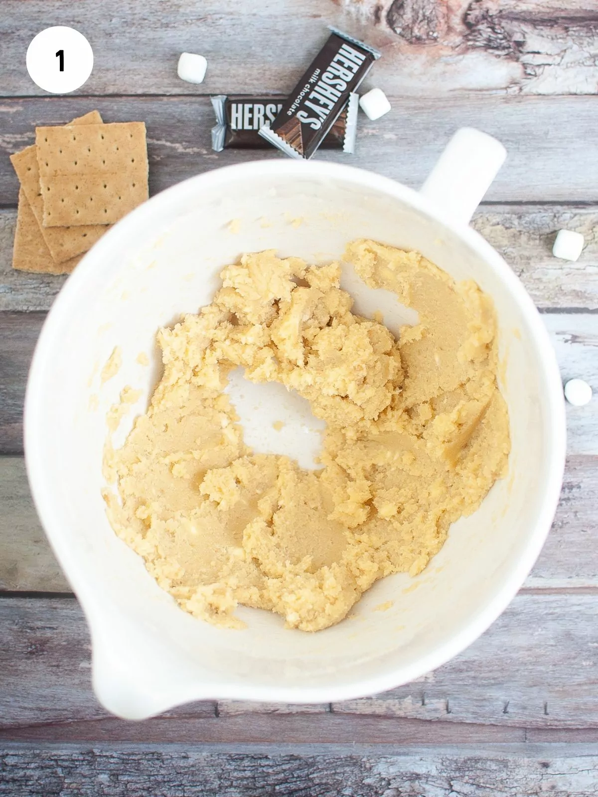 Butter and sugar combined in a white mixing bowl