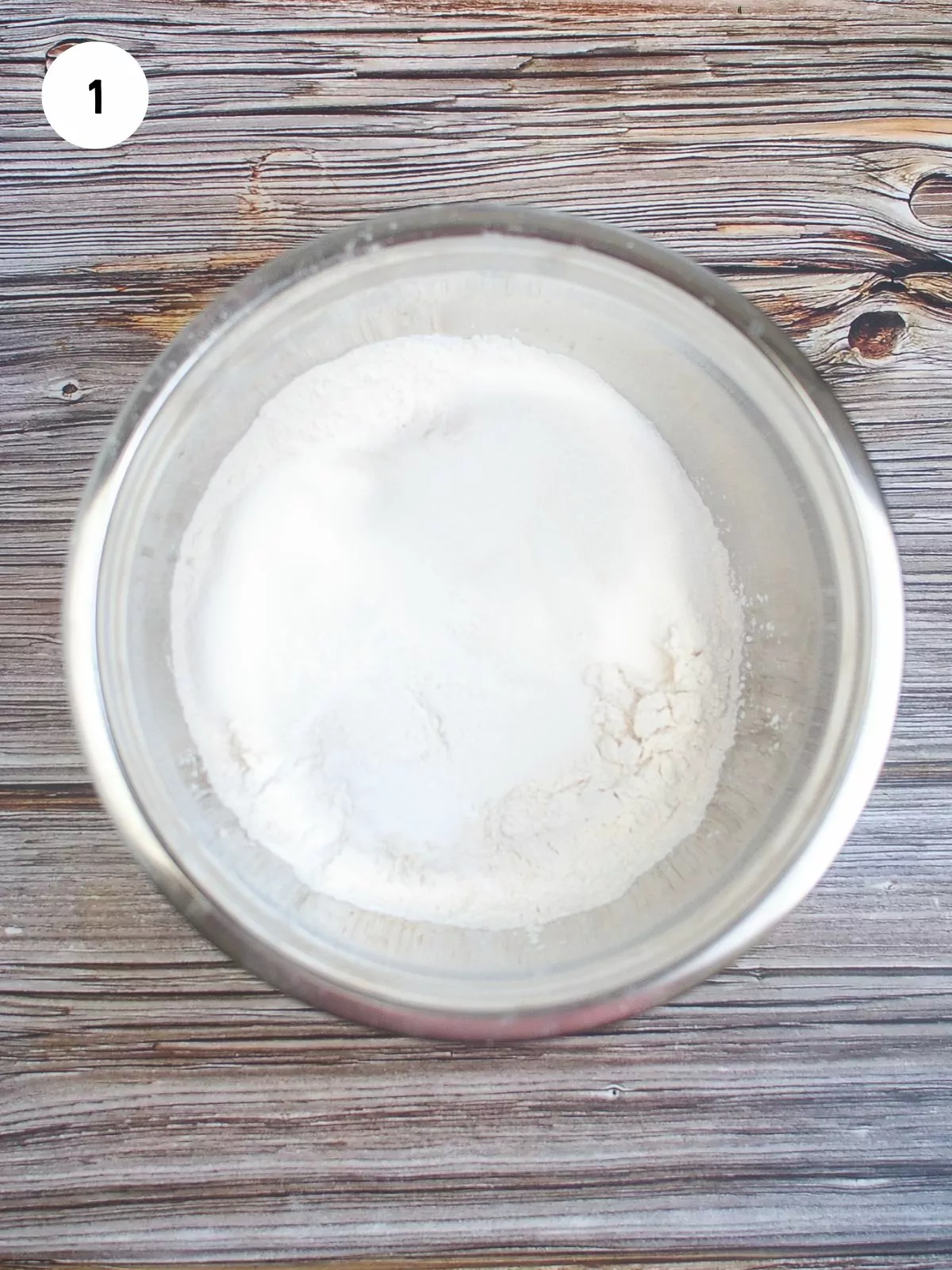 mixing bowl with flour, baking powder, baking soda, and salt