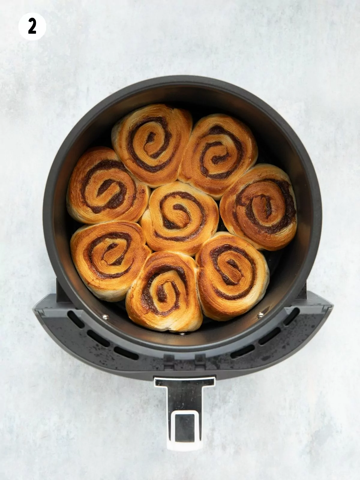 browned cinnamon rolls in an air fryer