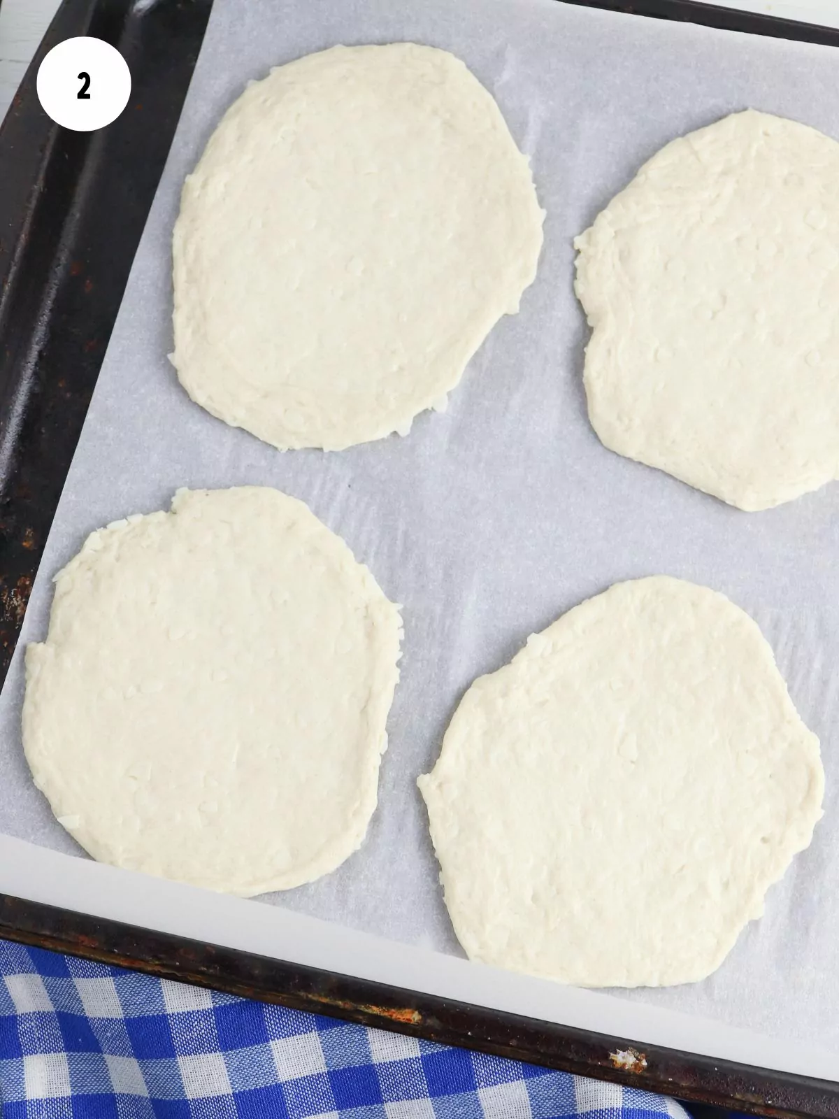 rolled out biscuits on a parchment lined baking tray