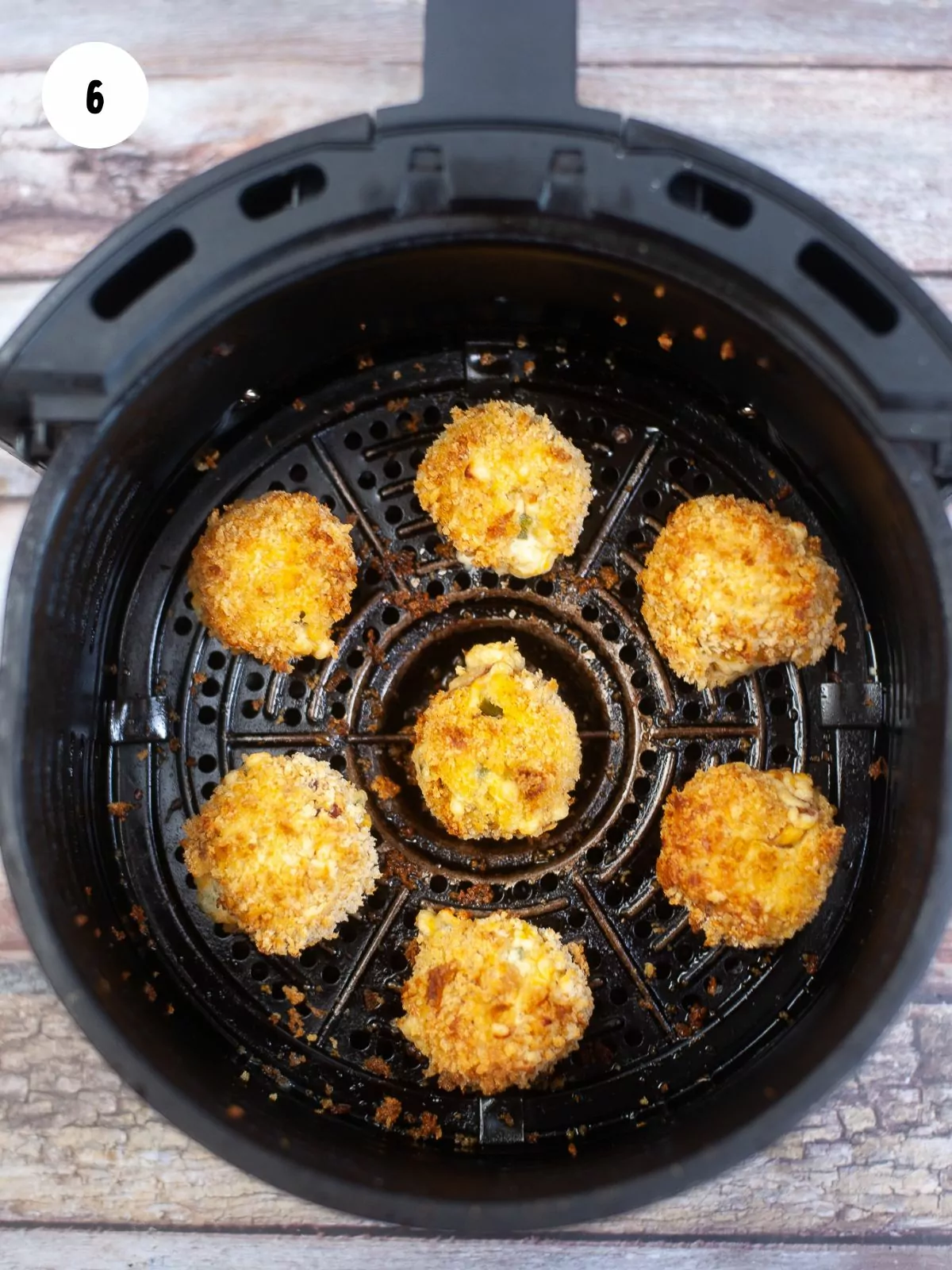 air fried jalapeno poppers in the basket of an air fryer