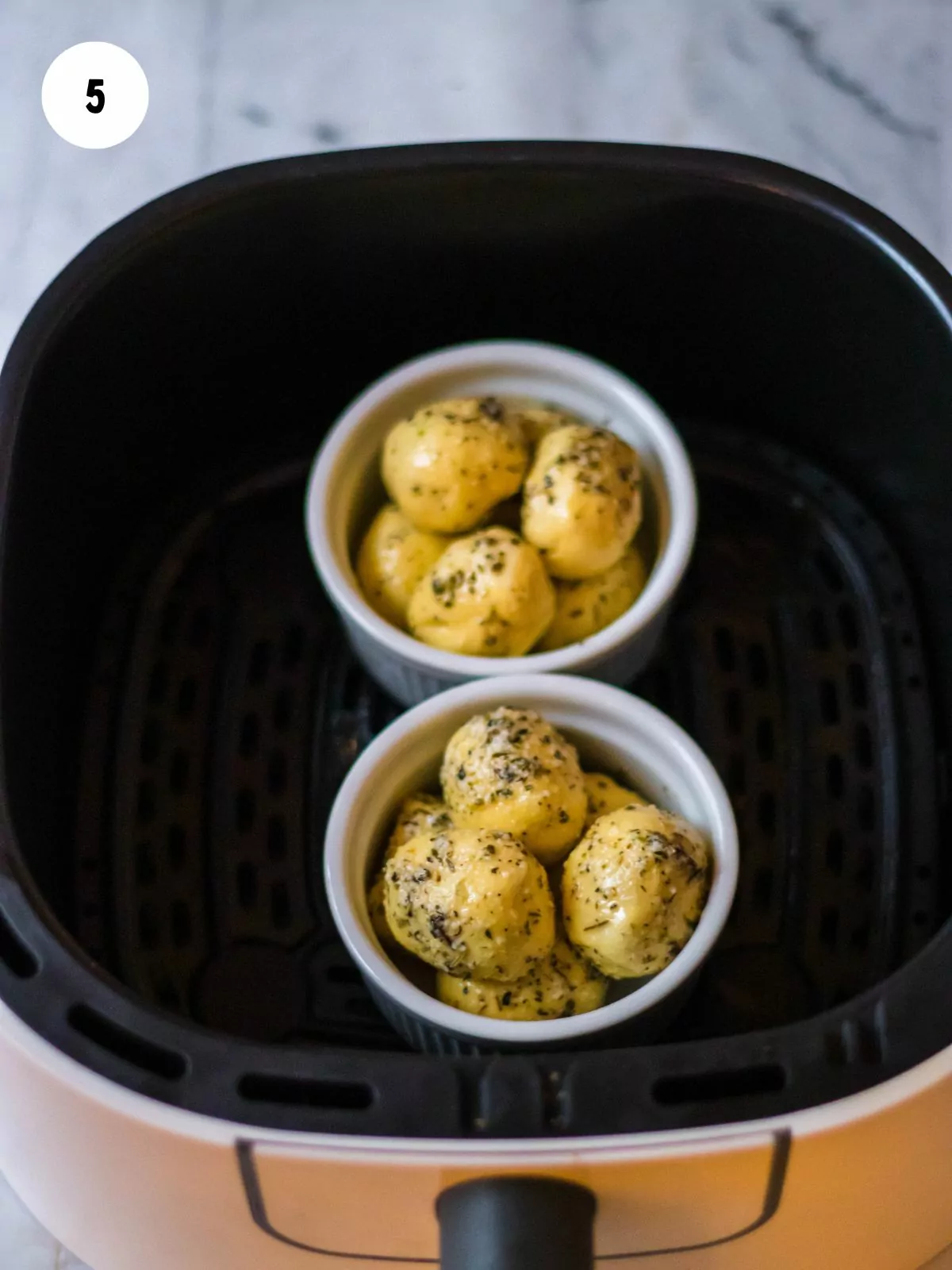 place balls of dough in ramekins and air fry