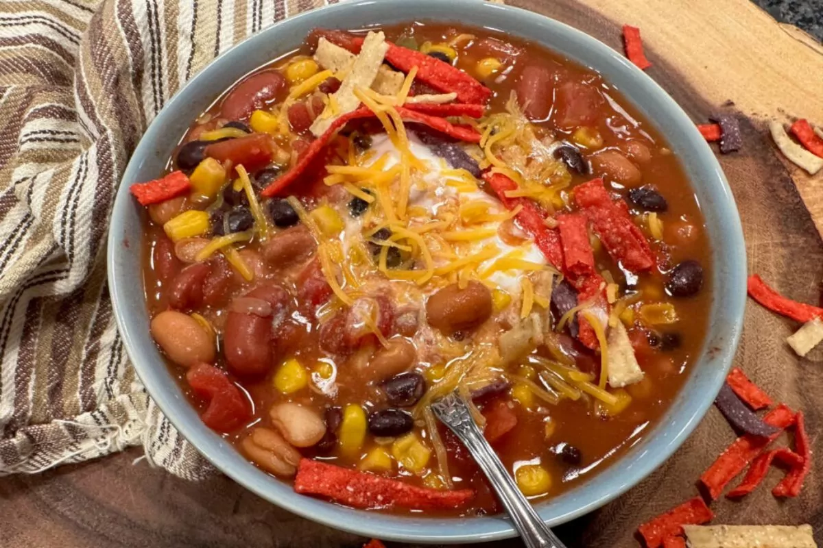 a bowl of soup with sour cream and tortilla strips.