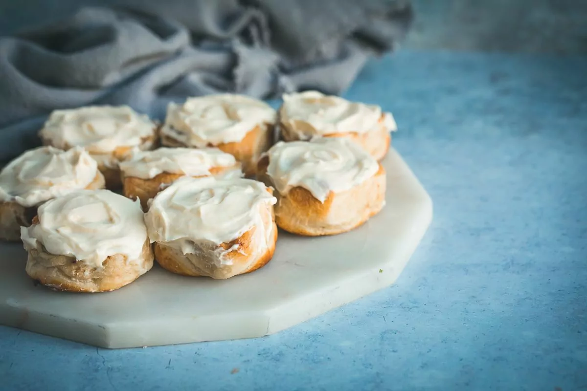 Air Fryer Cinnamon Rolls served on a marble cutting board