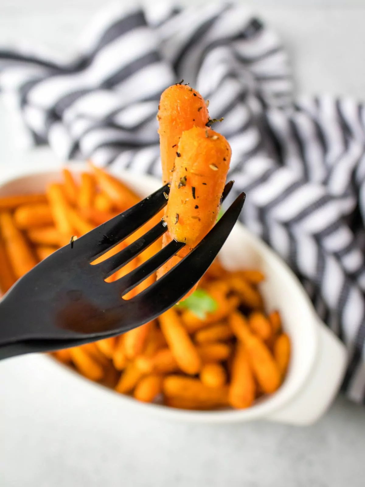 cooked Baby Carrots on a black fork