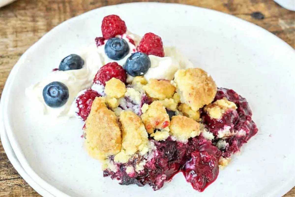 berry dump cake on white plate.