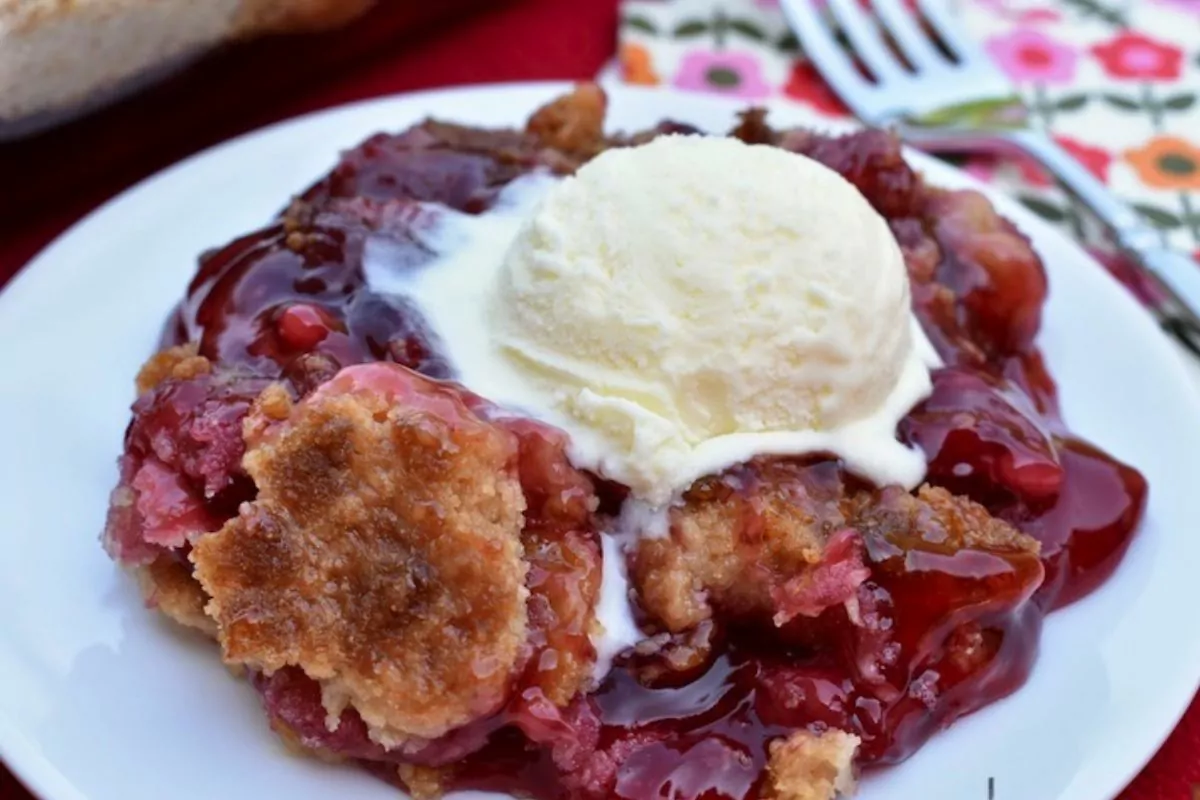 cherry dump cake on white plate.