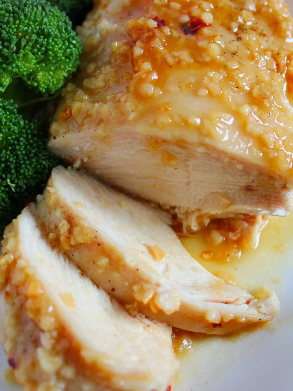 Close up of sliced chicken breast with honey garlic sauce